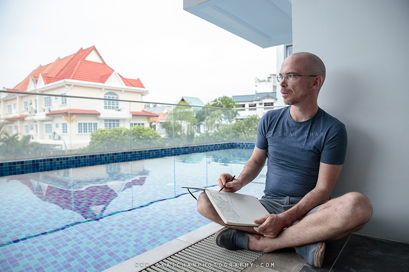 Artist sketching photoshoot session with Jerome Cheze at poolside (One Robey)