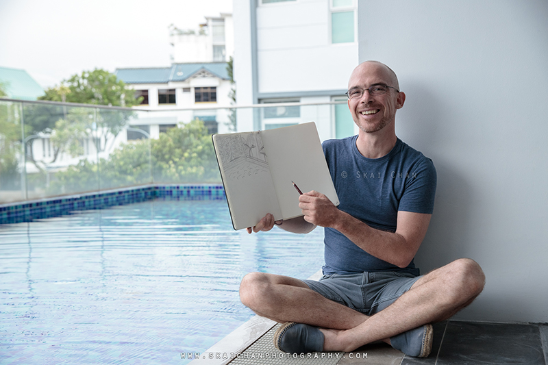 Artist sketching photoshoot session with Jerome Cheze at poolside (One Robey)
